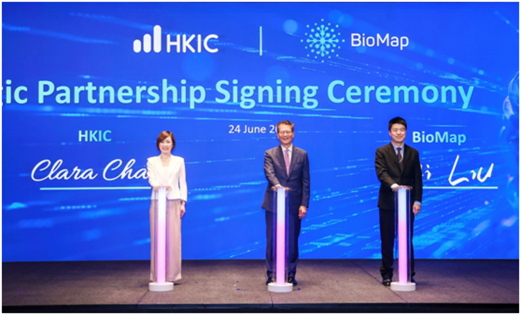 Clara Chan, CEO of HKIC (left), and Wei Liu, CEO of BioMap (right) signed the strategic partnership agreement, witnessed by Paul Chan, Financial Secretary of the Hong Kong SAR Government (centre)